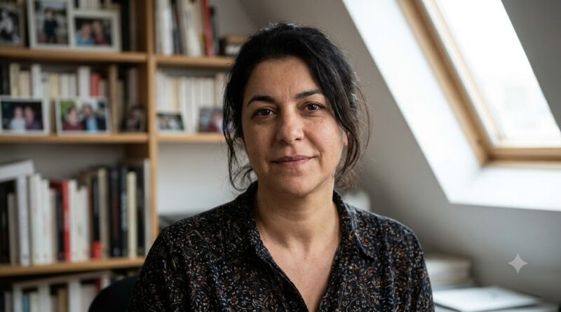 Marjane Satrapi, the author of the Persepolis book, smiling in her home library studio.